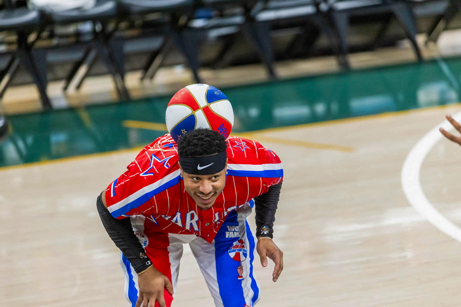 A Harlem Globetrotter balances a basketball on his back
