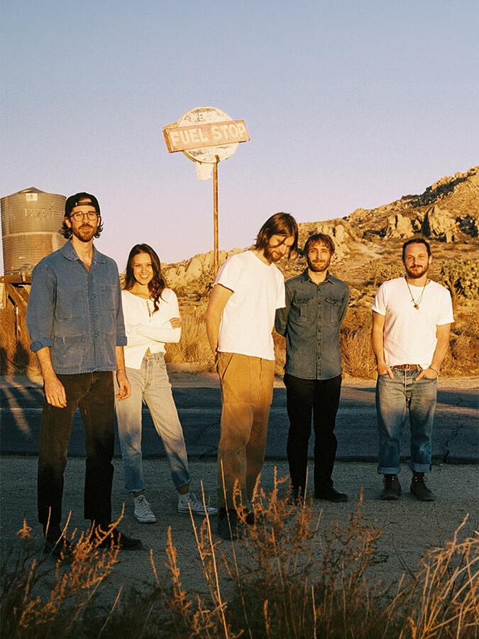 The 5 members of the Mt. Joy band on a desert road
