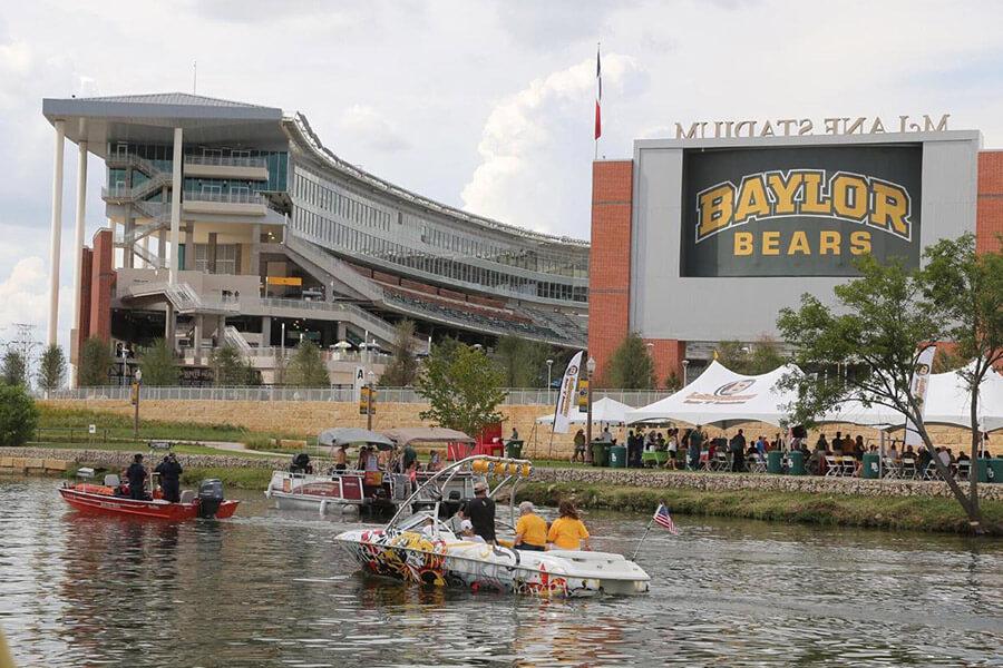 boats sailgate on the Brazos River in front of McLane Stadium 
